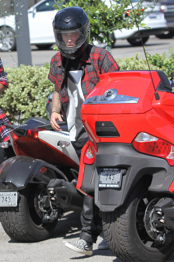 Justin Bieber switches out matte red Ferrari for a 3 wheeler ride around town
