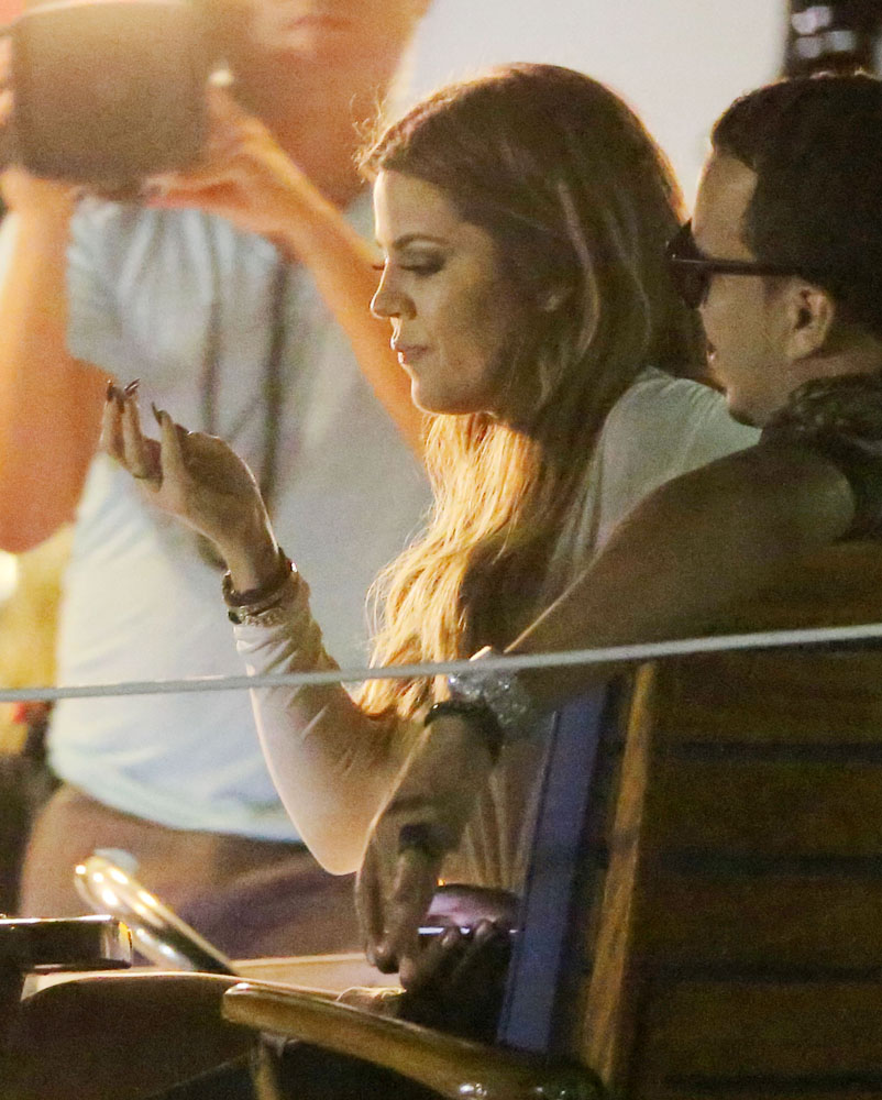 EXCLUSIVE: Khloe Kardashian picks her nose while Kendall Jenner, French Montana and the film crew looks on, on a yacht in NYC