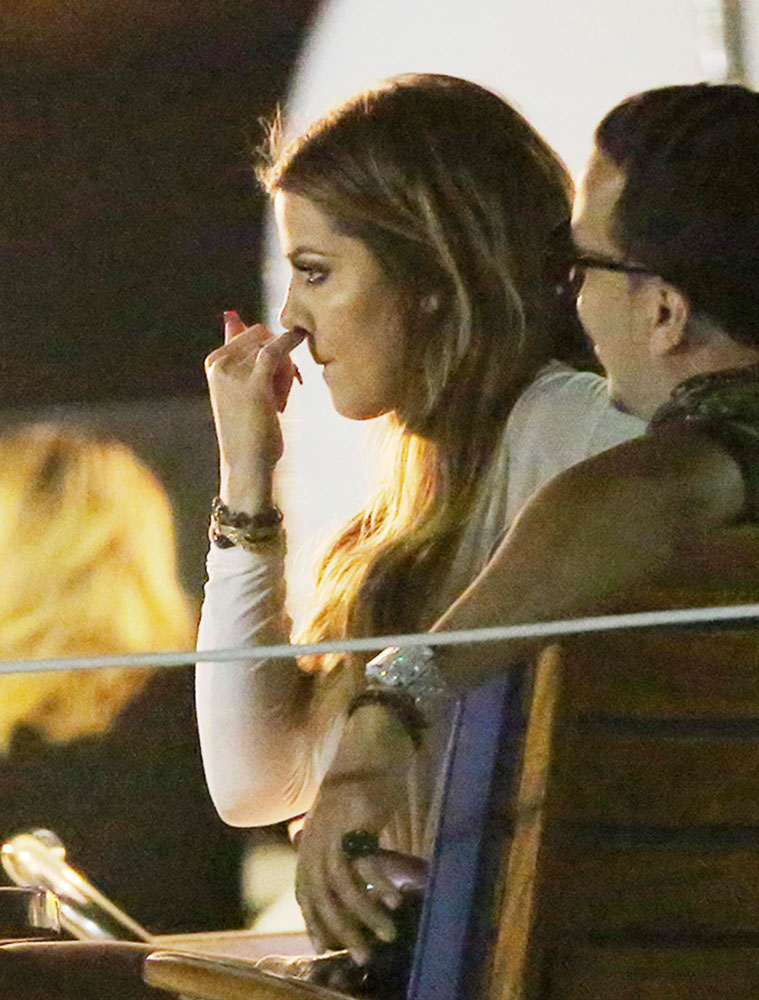 EXCLUSIVE: Khloe Kardashian picks her nose while Kendall Jenner, French Montana and the film crew looks on, on a yacht in NYC