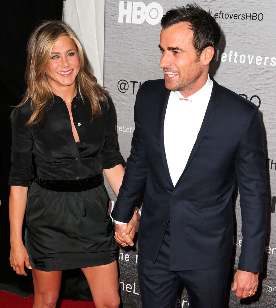 Actress Jennifer Aniston holds hands with her fiance Justin Theroux at the premiere of The Leftovers at Skirball Center at New York University on June 23, 2014 in New York City