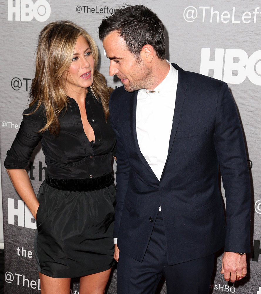 Actress Jennifer Aniston holds hands with her fiance Justin Theroux at the premiere of The Leftovers at Skirball Center at New York University on June 23, 2014 in New York City