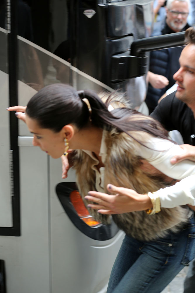 EXCLUSIVE: Adriana Lima bumps her head at a Maybelline photo shoot