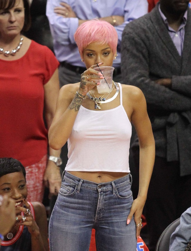 Rihanna shows her new hair color at the Clippers playoff game.