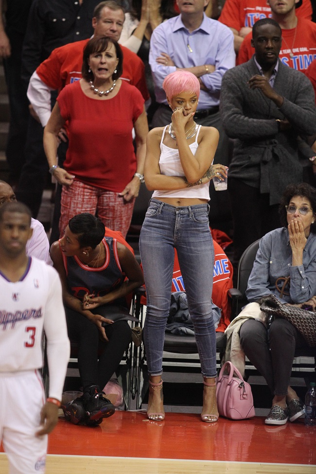 Rihanna shows her new hair color at the Clippers playoff game.