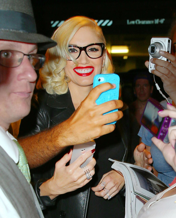 Gwen Stefani shows fans a picture of her son Kingston Rossdale on her phone in NYC